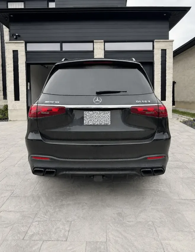 Before: rear of a black Mercedes-AMG GLS 63 covered in road film in a London, ON driveway