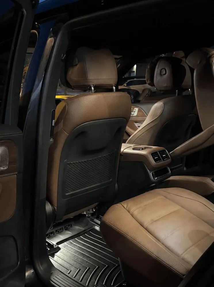 After: the same rear cabin with clean leather and spotless mats