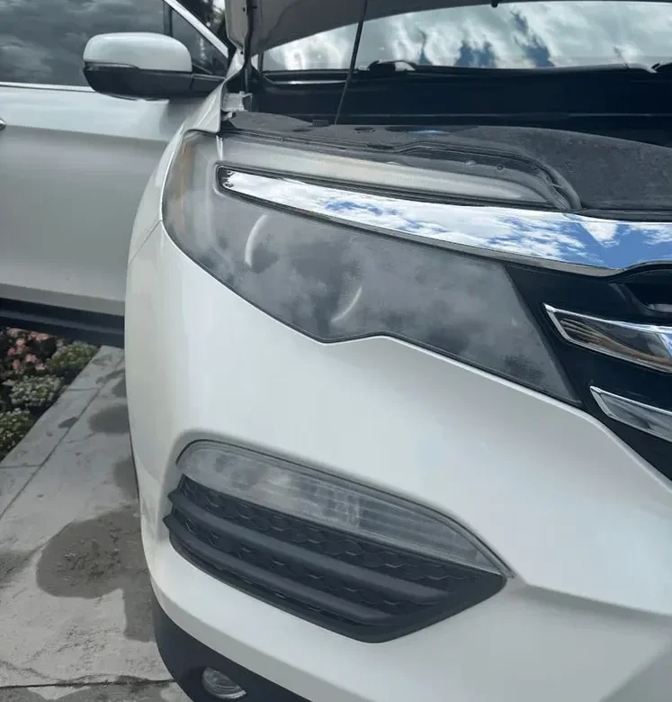 Before: cloudy, yellowed headlight lens on a white Honda SUV