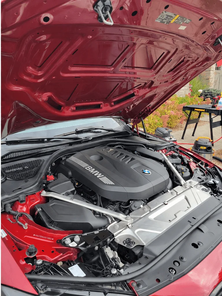 After engine bay cleaning: the same BMW M440i engine bay degreased and dressed
