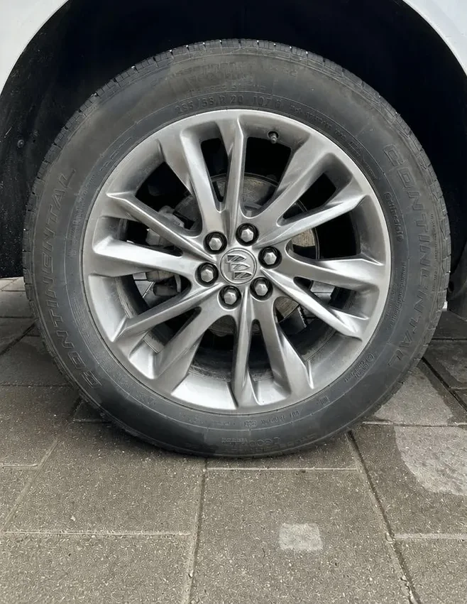 Before: SUV alloy wheel caked in brake dust with a faded tire