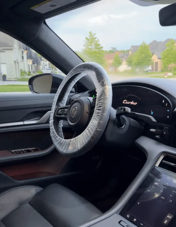 Porsche Taycan interior after a True North detail: clean leather seats and console