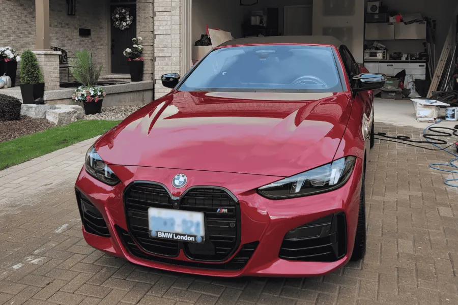 Red BMW M440i after a Premium Full Detail in a client's driveway